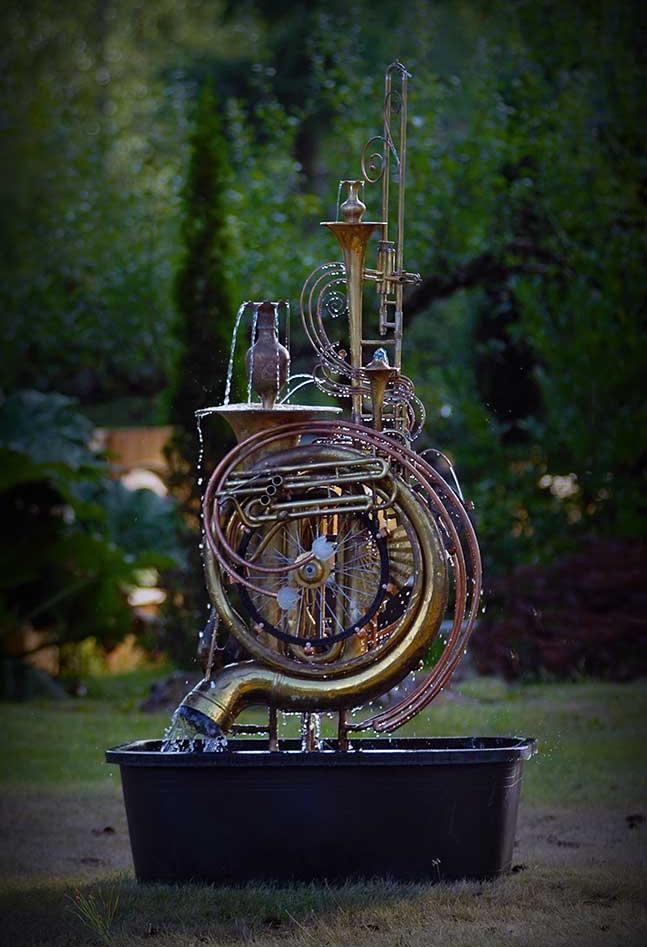 Musical instrument fountain made from upcycled copper tube, two tubas, a trumpet, a bicycle wheel and an assortment of copper and brass collectables. It comes complete with pump. This fountain is currently available for purchase @ $ 3,500. Please call or email for further info and shipping details.