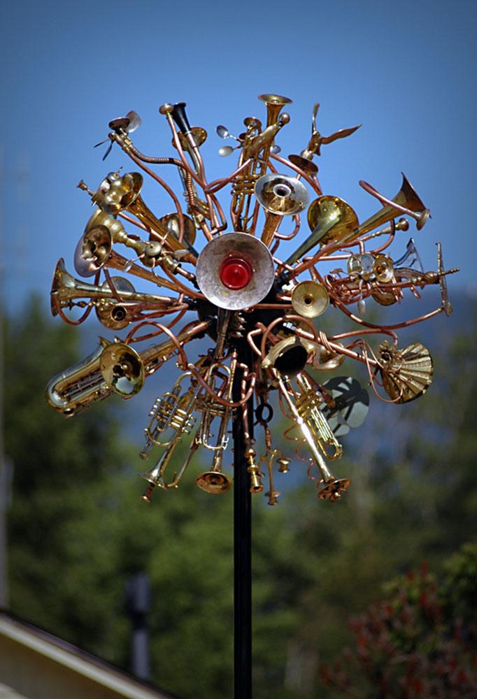 Wind sculpture made from upcycled musical instruments, brass and copper. 